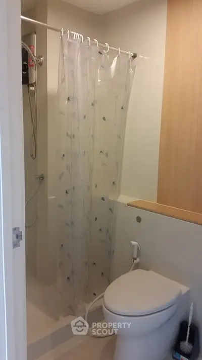 Compact bathroom with shower and toilet in modern apartment