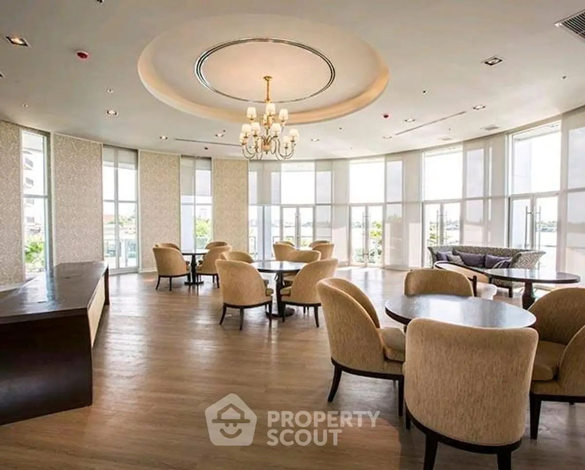 Elegant communal living area with large windows and stylish seating.