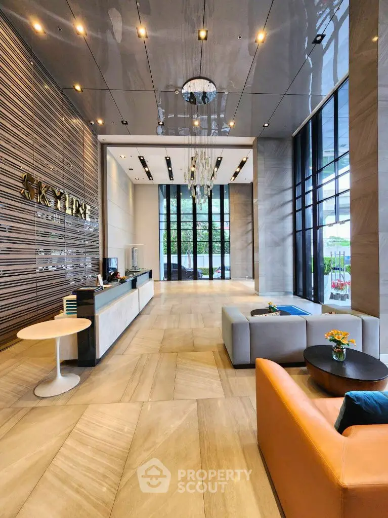 Luxurious modern lobby with elegant seating and high ceilings in a premium building.