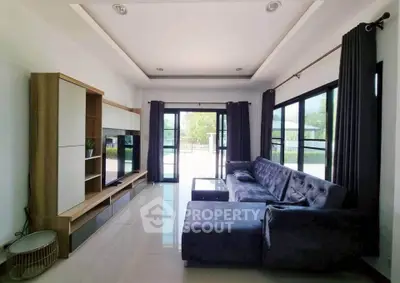 Spacious modern living room with large windows and stylish furniture