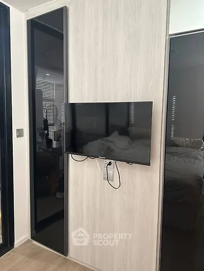Modern bedroom with mounted TV and sleek design elements