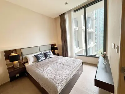 Modern bedroom with large window and stylish decor in urban apartment