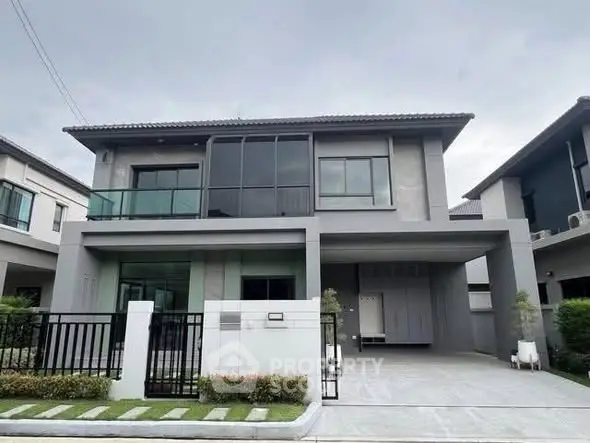 Modern two-story house with sleek design and spacious driveway