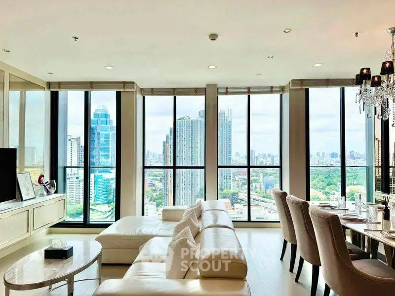 Luxurious living room with panoramic city views and elegant furnishings in a high-rise apartment.