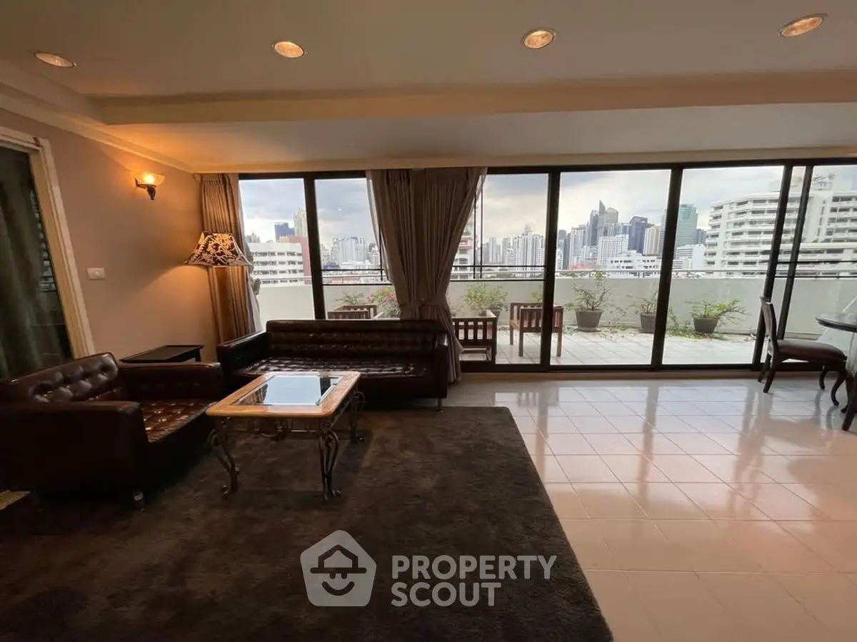 Spacious living room with city view and large balcony access