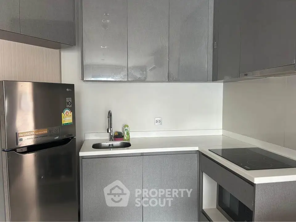 Modern kitchen with sleek grey cabinets and stainless steel appliances