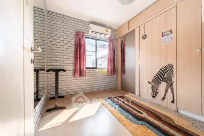 Bright bedroom with zebra-themed decor and ample natural light