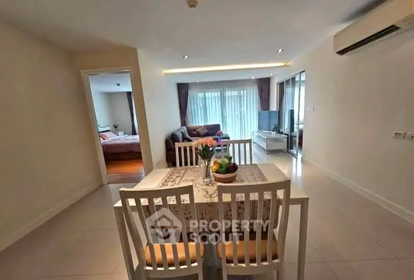 Spacious open-plan living and dining area with modern furnishings and natural light.