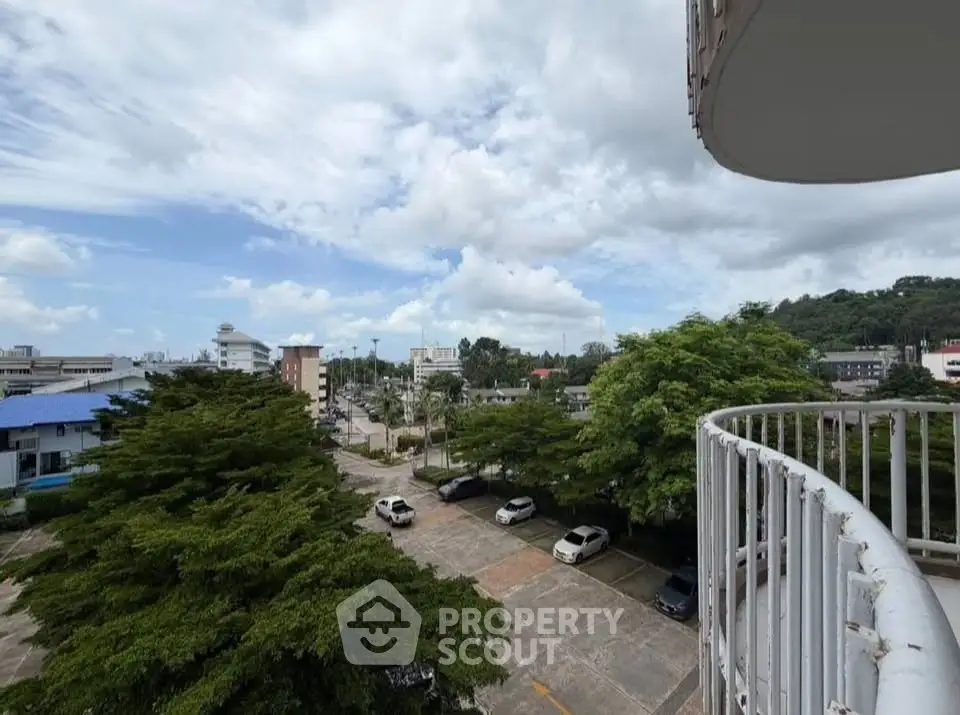Stunning balcony view overlooking lush greenery and cityscape, perfect for relaxation and urban living.