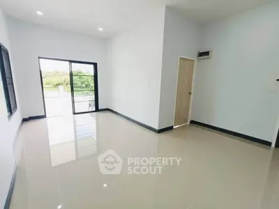 Spacious empty room with large windows and glossy tiled floor, perfect for customization.