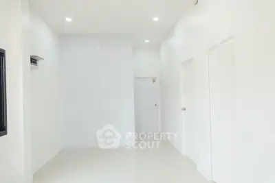 Minimalist white interior with clean lines and modern lighting