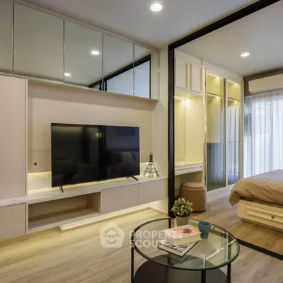 Modern living room with sleek TV unit and cozy bedroom view, featuring elegant decor and ambient lighting.