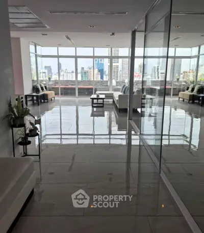 Spacious modern living room with city view and sleek glass walls