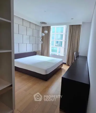 Modern bedroom with large window and stylish decor in urban apartment