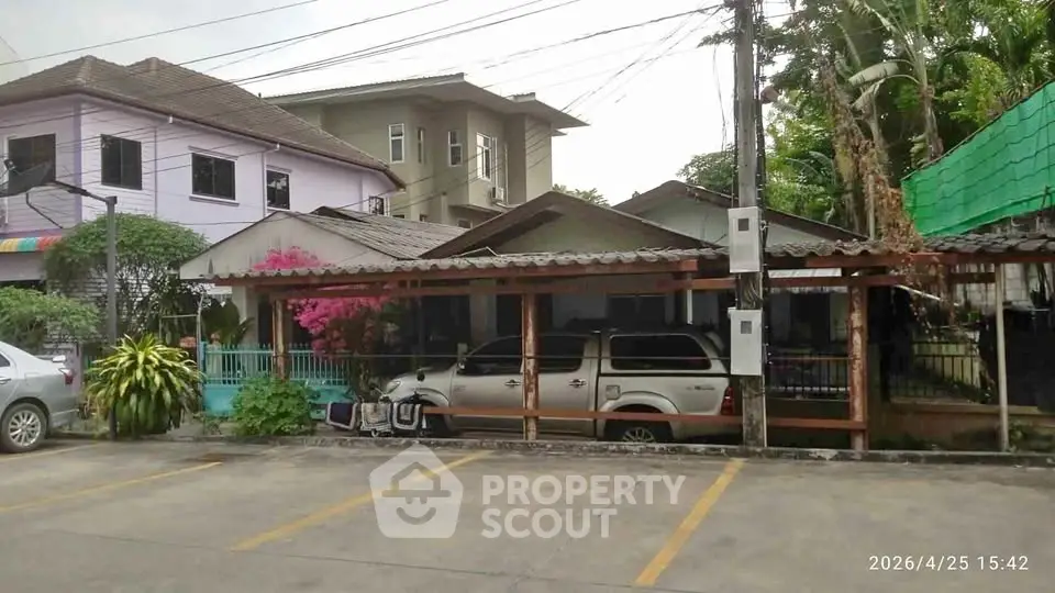 Charming residential property with multiple houses and parking area, ideal for family living.