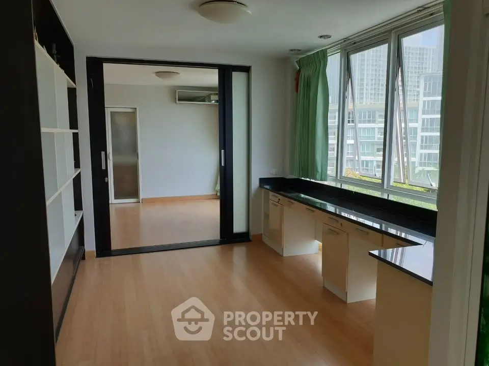 Spacious modern apartment with large windows and wooden flooring