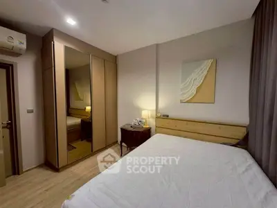 Cozy bedroom with mirrored wardrobe and elegant decor