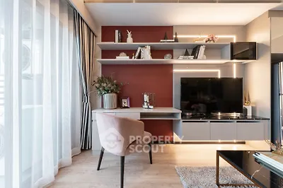 Modern living room with stylish decor, large TV, and elegant shelving