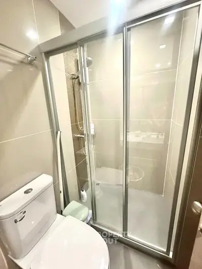 Modern bathroom with sleek shower enclosure and contemporary fixtures.