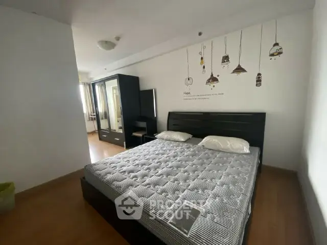 Spacious bedroom with modern decor and ample natural light