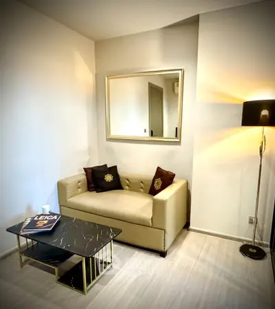 Cozy living room with elegant sofa, stylish lamp, and chic coffee table in modern apartment.