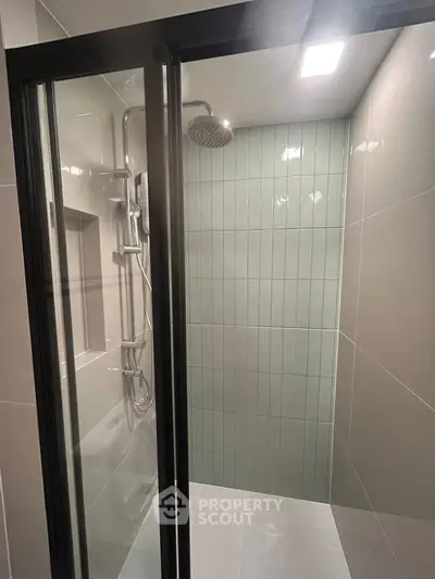Modern bathroom shower with sleek glass doors and contemporary fixtures