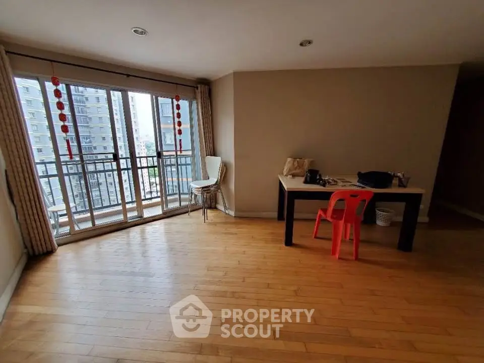 Spacious living room with balcony view in modern apartment