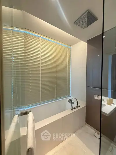 Modern bathroom with sleek bathtub and stylish blinds, perfect for relaxation.