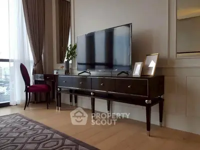 Elegant living room with modern TV stand, plush chair, and large window with city view.