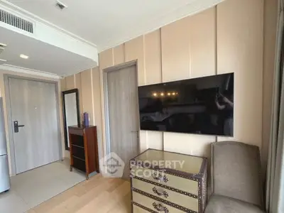 Modern living room with wall-mounted TV and stylish furniture in a contemporary apartment.