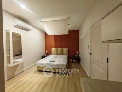 Spacious bedroom with modern decor and air conditioning in a stylish apartment.