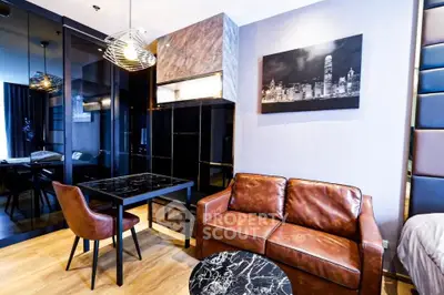 Modern living room with stylish decor and leather sofa in a contemporary apartment.