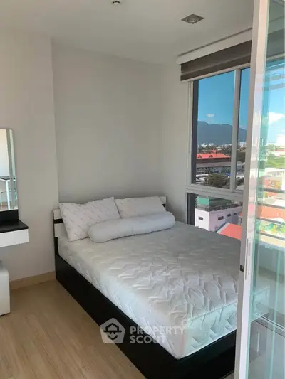 Cozy bedroom with mountain view and modern decor in a bright apartment.