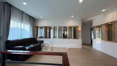 Spacious modern living room with elegant built-in cabinets and large windows