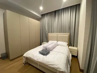 Modern bedroom with elegant design and cozy ambiance, featuring a comfortable bed and ample storage space.