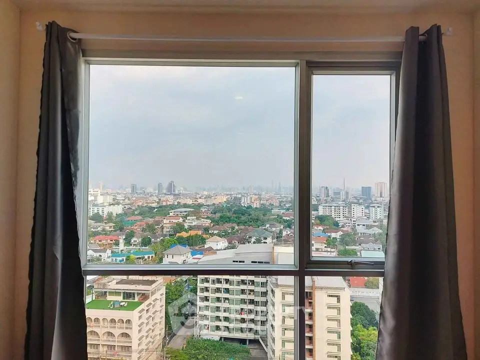 Stunning cityscape view from a high-rise apartment window, showcasing urban living at its finest.