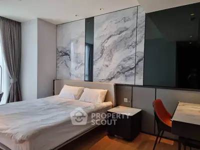 Luxurious modern bedroom with marble accent wall and elegant furnishings