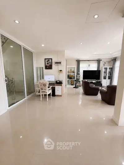 Spacious modern living room with elegant decor and large windows for natural light.
