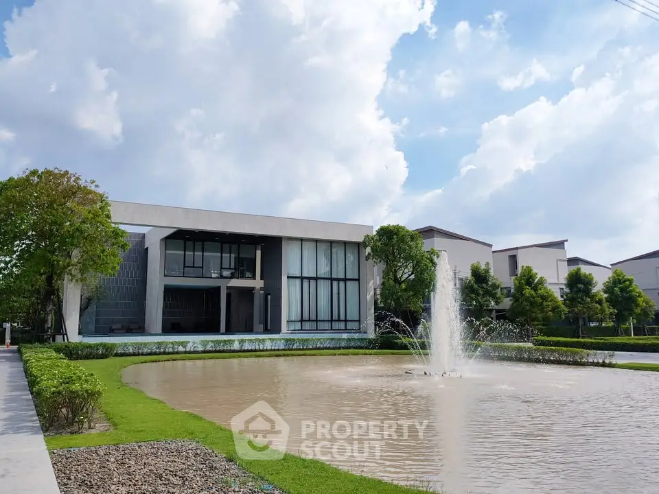 Luxurious modern home with stunning water feature and lush landscaping