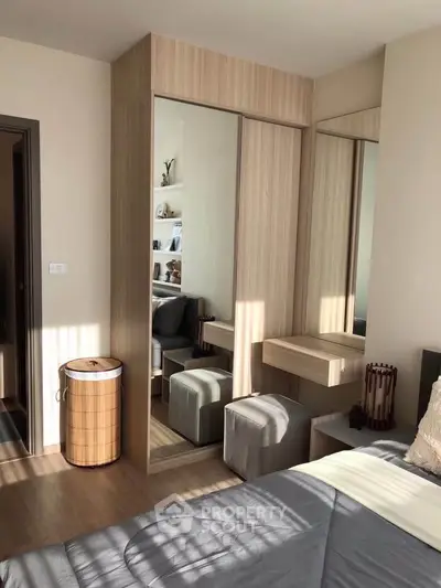 Modern bedroom with stylish wooden wardrobe and cozy seating area