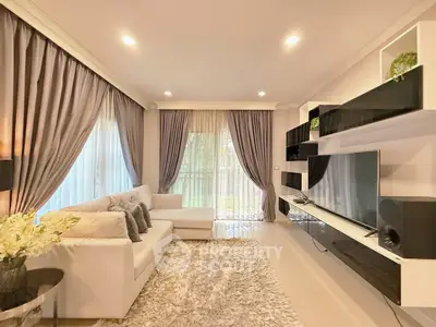 Elegant living room with modern decor and large windows for natural light.