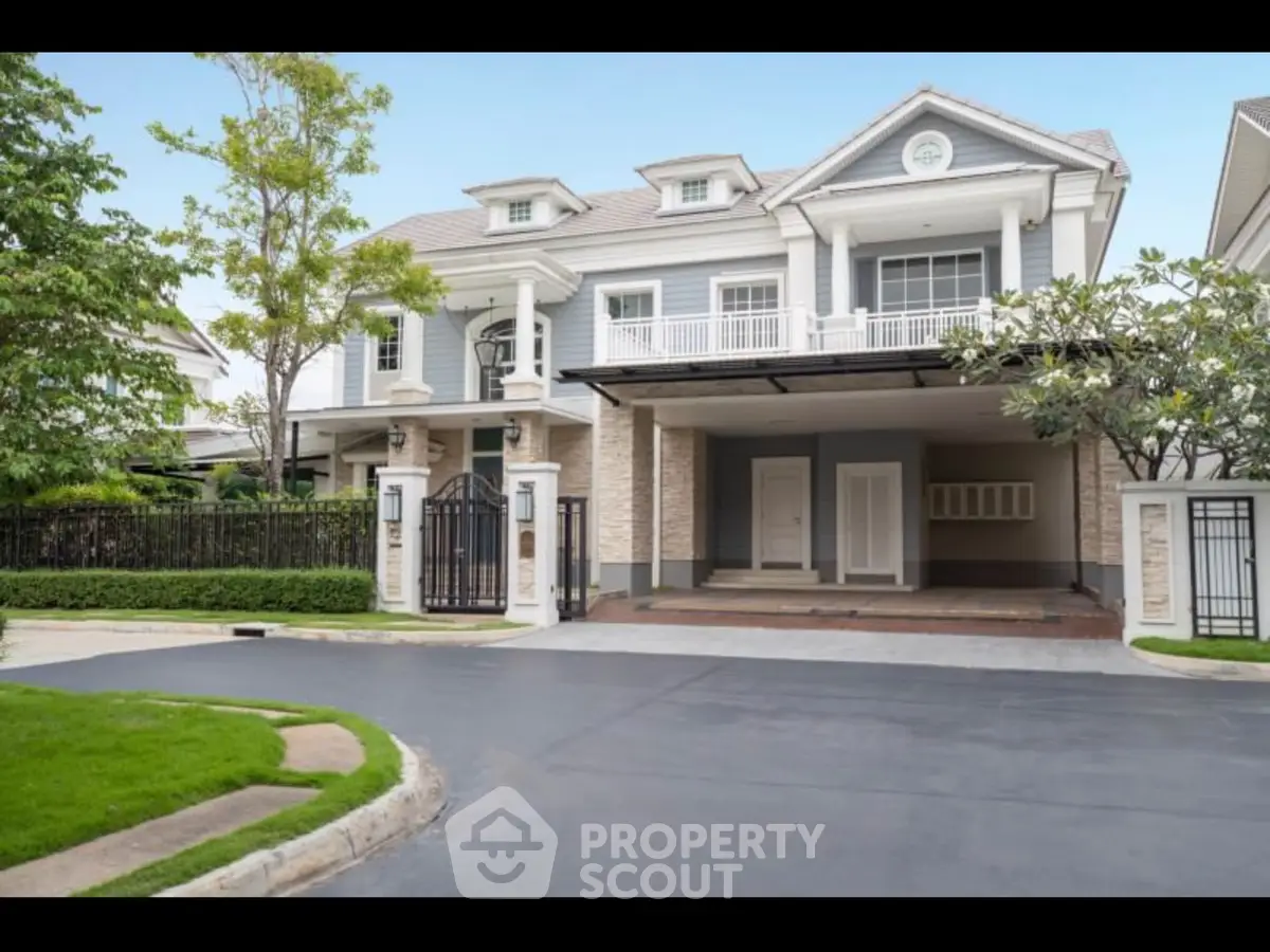 Elegant two-story house with manicured lawn and spacious driveway in a serene neighborhood.