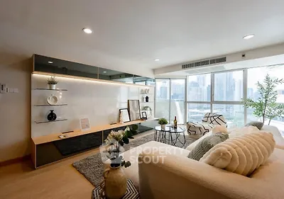 Modern living room with city view, stylish decor, and natural light.