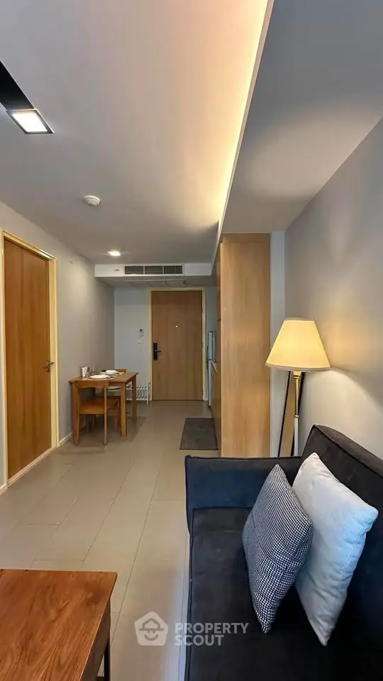 Modern living room with stylish furniture and ambient lighting in a contemporary apartment.