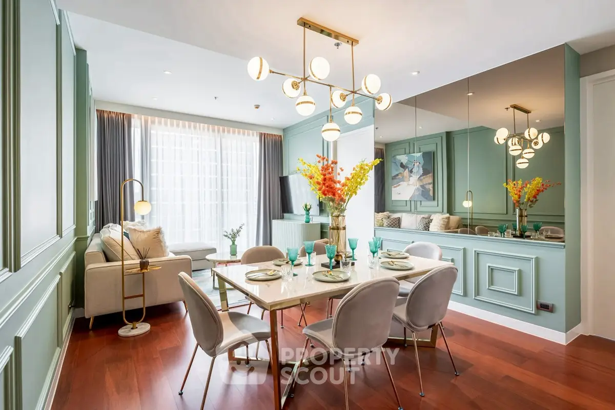 Elegant dining room with modern chandelier and stylish decor in a luxurious apartment.