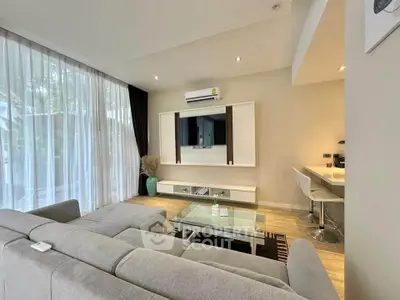 Modern living room with sleek furniture and natural light, featuring a stylish open layout and contemporary design.