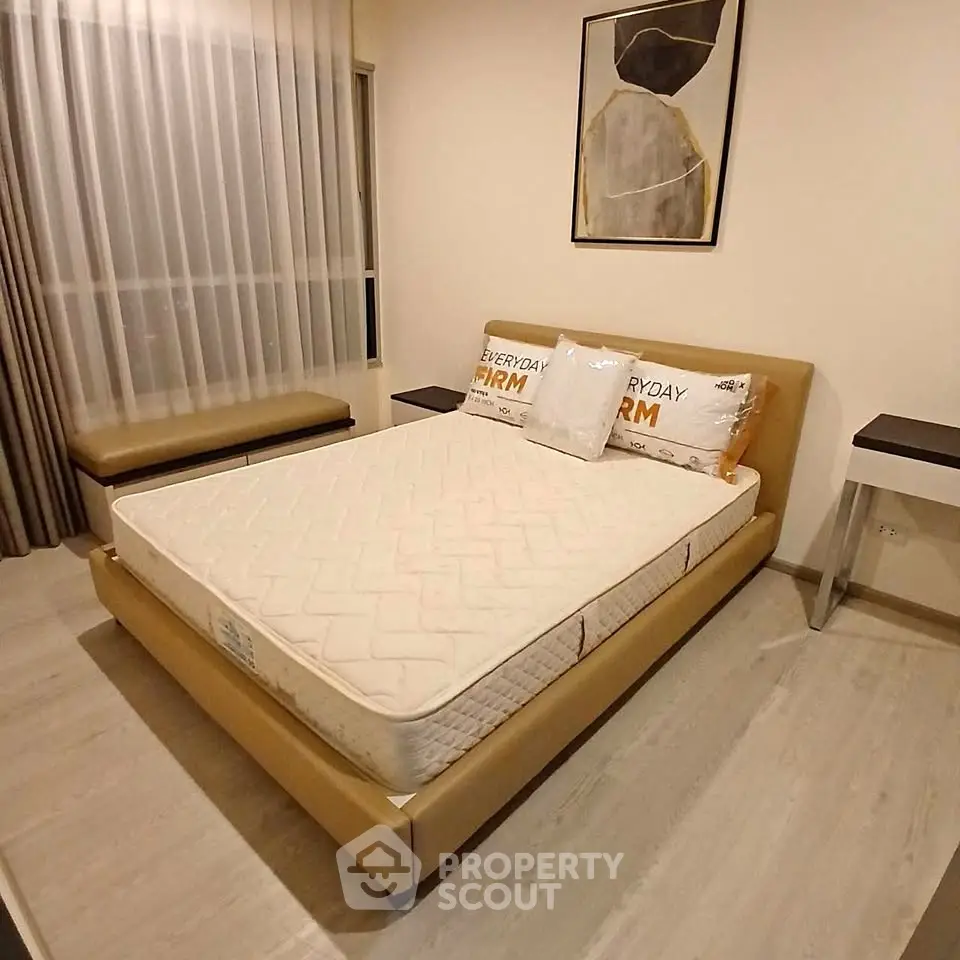 Modern bedroom with stylish decor and comfortable bed in a cozy apartment setting.