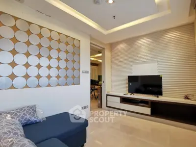Modern living room with stylish wall decor and flat-screen TV