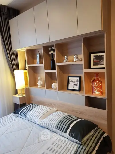 Cozy bedroom with stylish shelving and modern decor accents.