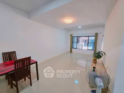 Spacious minimalist living room with dining area and large windows